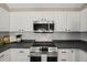 Modern kitchen with stainless steel appliances and white cabinets at 2773 Clifton Avenue, Creedmoor, NC 27522