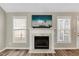 Bright living room with fireplace, hardwood floors, and large windows at 2773 Clifton Avenue, Creedmoor, NC 27522