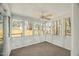 Relaxing screened porch with ceiling fan and neutral carpeting at 2773 Clifton Avenue, Creedmoor, NC 27522