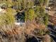 An aerial view showcasing a home nestled in a wooded area, offering privacy and tranquility at 3 Acornridge Ct, Durham, NC 27707