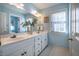 Light blue bathroom with double vanity and hexagon tile floor at 3 Acornridge Ct, Durham, NC 27707