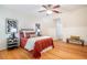 Spacious bedroom featuring hardwood floors, a ceiling fan, and natural light at 3 Acornridge Ct, Durham, NC 27707