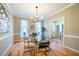 Spacious dining room with hardwood floors and large windows, showcasing natural light at 3 Acornridge Ct, Durham, NC 27707