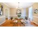 Bright dining room features hardwood floors, a glass table, and a modern chandelier at 3 Acornridge Ct, Durham, NC 27707
