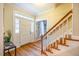 Bright entryway with hardwood floors, white door and staircase at 3 Acornridge Ct, Durham, NC 27707