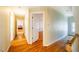 Upstairs hallway with hardwood floors and access to bedrooms at 3 Acornridge Ct, Durham, NC 27707
