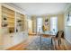 Home office with built-in shelving, hardwood floors, and a large window at 3 Acornridge Ct, Durham, NC 27707