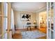 Home office with built-in shelving, hardwood floors, and a large window at 3 Acornridge Ct, Durham, NC 27707