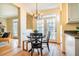 Eat-in kitchen with black table and chairs, hardwood floors, and French doors at 3 Acornridge Ct, Durham, NC 27707