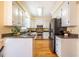 Kitchen boasts granite countertops, stainless steel appliances, and white cabinets at 3 Acornridge Ct, Durham, NC 27707