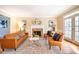 Living room with a fireplace, hardwood floors and leather furniture at 3 Acornridge Ct, Durham, NC 27707