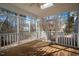 Bright screened porch with wood floors and wooded views at 3 Acornridge Ct, Durham, NC 27707