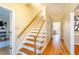 Elegant staircase with hardwood steps and white railings at 3 Acornridge Ct, Durham, NC 27707