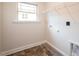 Bright laundry room with built-in shelving and tile floor at 40 Northwood Dr, Fuquay Varina, NC 27526