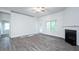 Open living room with fireplace and access to back patio at 40 Northwood Dr, Fuquay Varina, NC 27526