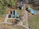 Aerial view of a home with a long drive, surrounded by woods, with a pool house and pool at 413 Johnson Town Rd, Zebulon, NC 27597