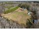 Scenic aerial view of the property with the home, pool, and large green space at 413 Johnson Town Rd, Zebulon, NC 27597