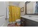 Charming bathroom with dark brown vanity and yellow floral shower curtain at 413 Johnson Town Rd, Zebulon, NC 27597