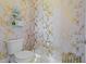 Stylish powder room with gold bird wallpaper and white toilet at 413 Johnson Town Rd, Zebulon, NC 27597