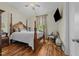 Bright bedroom featuring a wooden four-poster bed and hardwood floors at 413 Johnson Town Rd, Zebulon, NC 27597