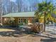 Cabana with green metal roof near pool and wooded area at 413 Johnson Town Rd, Zebulon, NC 27597