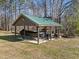 Open carport featuring a boat and other vehicles, offering covered parking and storage at 413 Johnson Town Rd, Zebulon, NC 27597