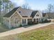 Charming ranch style home features stone accents, inviting front porch, and an attached two car garage at 413 Johnson Town Rd, Zebulon, NC 27597