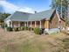 Log cabin style home with a covered porch and well-maintained landscaping at 413 Johnson Town Rd, Zebulon, NC 27597