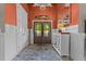 Stylish foyer with stone flooring, an orange accent wall, and a decorative entryway table at 413 Johnson Town Rd, Zebulon, NC 27597
