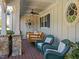 Relaxing front porch with a swing, comfortable seating, and decorative accents at 413 Johnson Town Rd, Zebulon, NC 27597