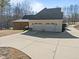 Detached garage with multiple bays and spacious driveway, great for car enthusiasts at 413 Johnson Town Rd, Zebulon, NC 27597