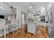 Bright kitchen with white cabinets, stainless steel appliances and hardwood floors at 413 Johnson Town Rd, Zebulon, NC 27597
