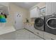 Bright laundry room featuring washer, dryer, and ample cabinetry at 413 Johnson Town Rd, Zebulon, NC 27597