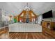 Spacious living room featuring a fireplace, wood floors, and high vaulted ceiling at 413 Johnson Town Rd, Zebulon, NC 27597
