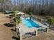 Aerial view of inviting pool with slide, and spacious backyard at 413 Johnson Town Rd, Zebulon, NC 27597