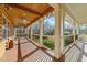 Long wooden porch with ceiling fan, offering views of the backyard at 413 Johnson Town Rd, Zebulon, NC 27597