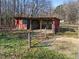 Rustic shed with covered area and gated entrance, perfect for storage or animals at 413 Johnson Town Rd, Zebulon, NC 27597