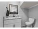Small bathroom with granite countertop and white cabinets at 420 W 10Th St, Siler City, NC 27344