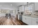 Open kitchen features white cabinets, granite counters, and stainless steel appliances at 420 W 10Th St, Siler City, NC 27344