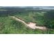 Aerial view of lots and roads in a wooded area with lake view at 432 Firefly Overlook, Pittsboro, NC 27312