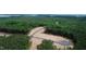 Aerial view of lots and roads in a wooded area with lake view at 432 Firefly Overlook, Pittsboro, NC 27312