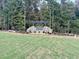 Modern community entrance sign with pergola and landscaping at 432 Firefly Overlook, Pittsboro, NC 27312