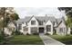 Stunning two-story home with a brick and shingle exterior, large windows, and a walkway at 432 Firefly Overlook, Pittsboro, NC 27312
