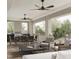 Spacious patio features ceiling fans, comfortable seating, and an outdoor kitchen at 432 Firefly Overlook, Pittsboro, NC 27312