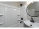 Bathroom with white tub and shower and updated matte black fixtures at 601 Rose St, Rocky Mount, NC 27801