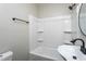 Bathroom with white tub and shower and updated matte black fixtures at 601 Rose St, Rocky Mount, NC 27801