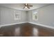 Light and bright bedroom features hardwood floors, neutral walls, and two updated windows at 601 Rose St, Rocky Mount, NC 27801