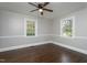 Bright bedroom features hardwood floors, neutral walls, and two updated windows at 601 Rose St, Rocky Mount, NC 27801