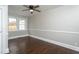 Bedroom features hardwood floors, neutral walls, an updated window and a ceiling fan at 601 Rose St, Rocky Mount, NC 27801