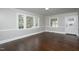 Sunlit empty room boasts hardwood floors, neutral paint, and large windows at 601 Rose St, Rocky Mount, NC 27801
